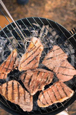 Grilling meat on charcoal grill