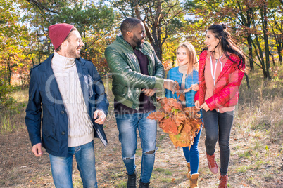 Happy friends walking in autumn park