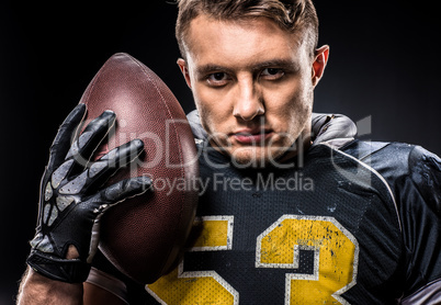 American football player holding ball