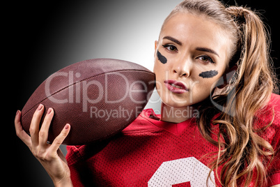 American football player holding ball