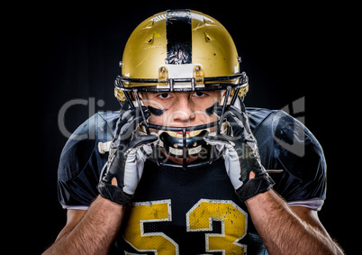 Football player adjusting helmet