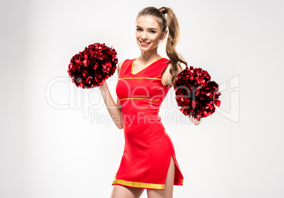 Cheerleader posing with pom-poms