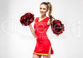 Cheerleader posing with pom-poms