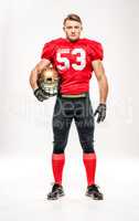 Football player holding helmet