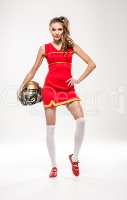 Cheerleader posing with helmet