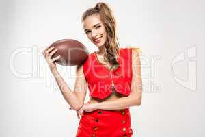 Female cheerleader with rugby ball