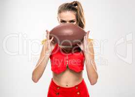 Female cheerleader with rugby ball