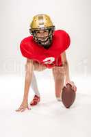 american football player posing with ball