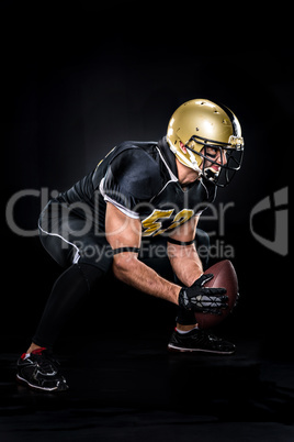 American football player crouching