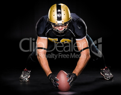 American football player holding ball