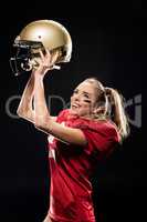 Female football player cheering with helmet