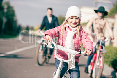 Cute little girl riding bicycle