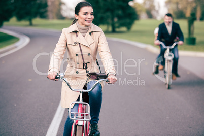 Beautiful smiling woman riding bicycle