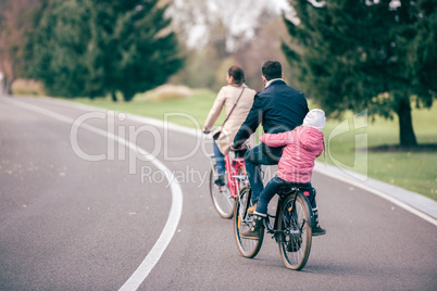Family riding bicycles in park