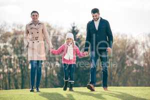 Happy family walking in park