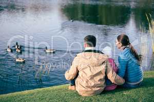 Family looking at lake with ducks