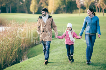Happy family walking near lake