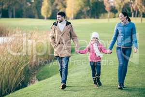 Happy family walking near lake