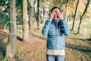 Woman covering eyes with hands