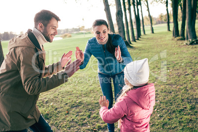 Happy family playing in park