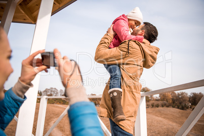 Happy father playing with little daughter