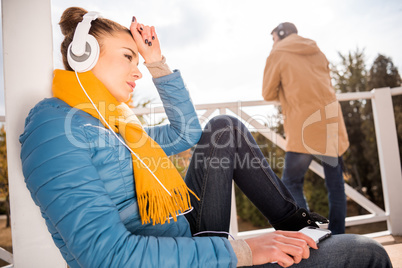 Beautiful woman in headphones listening music