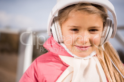 Smiling little girl in white headphones