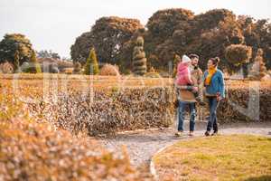 Happy family walking in park