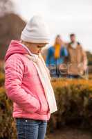 Sad little girl standing outdoors