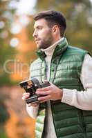 Handsome man holding instant camera