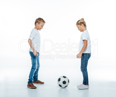 Smiling children playing with soccer ball