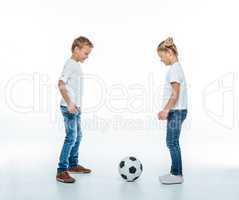 Smiling children playing with soccer ball