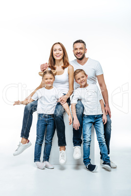 Happy parents with children in white t-shirts