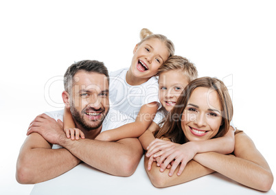 Smiling family in white t-shirts hugging