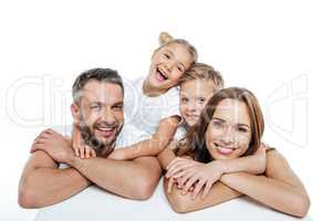 Smiling family in white t-shirts hugging