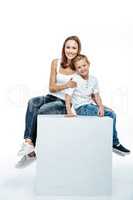 Smiling mother with son sitting togethe