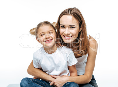 Smiling mother hugging daughter