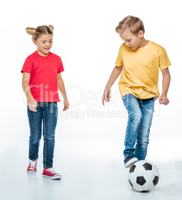 siblings playing with soccer ball