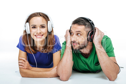 Couple in headphones listening to music