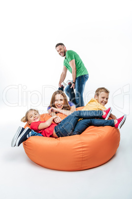 Family having fun in sack-chair