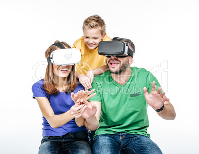 Family using virtual reality headsets