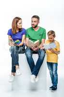 family with one child reading books