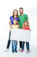 family standing with blank white card