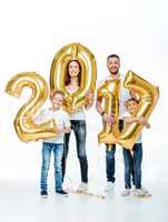 Happy family holding golden balloons