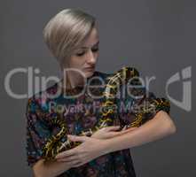 Young woman holding snake