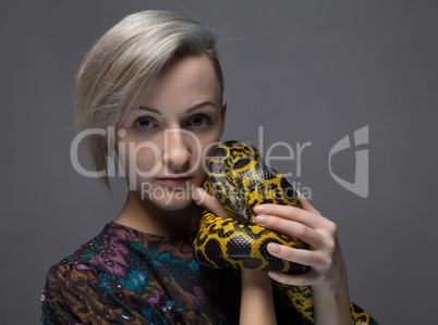 Blond woman holding anaconda