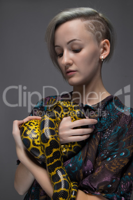 Blond woman holding snake