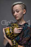 Blond woman holding snake