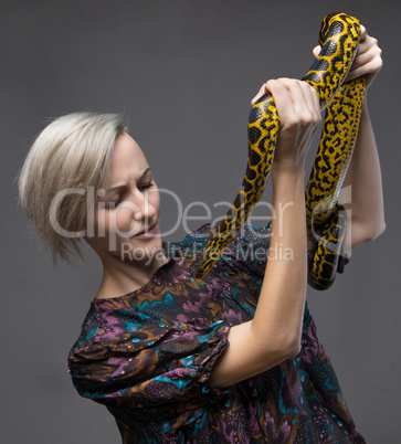 Scared woman and yellow anaconda