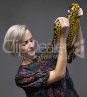 Scared woman and yellow anaconda